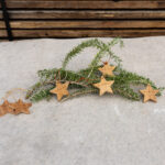 Thitsa’s Twinkle ornament made from solid NG Rosewood, featuring a smooth natural grain and warm reddish-brown tones. Designed as a small decorative hanging piece for Christmas or home décor.