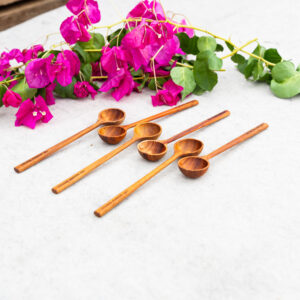 Elegant teaspoon carved from solid NG Rosewood, showcasing rich natural grain and a smooth, seamless finish.