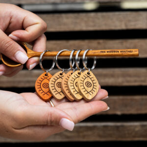 ooden Mati keyring made from solid PNG Rosewood, showcasing the traditional Greek eye symbol for protection and style.